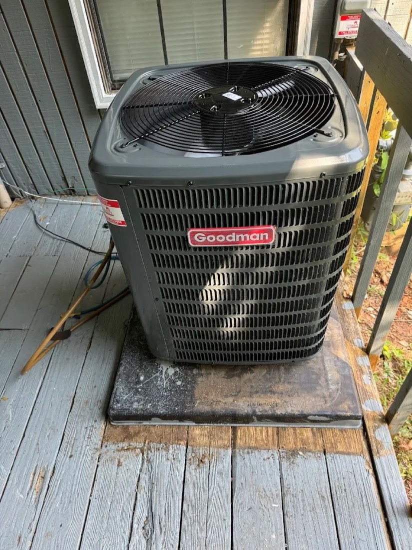 Goodman outdoor AC condenser on a wood deck installed by Dynasty